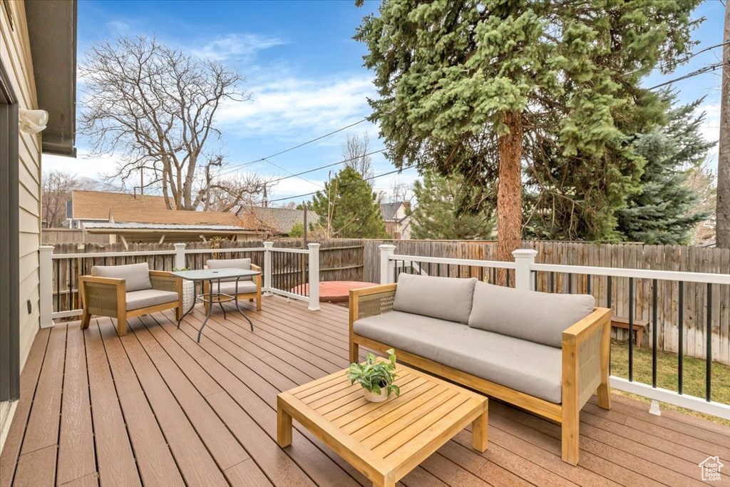 Deck featuring an outdoor living space and a fenced backyard