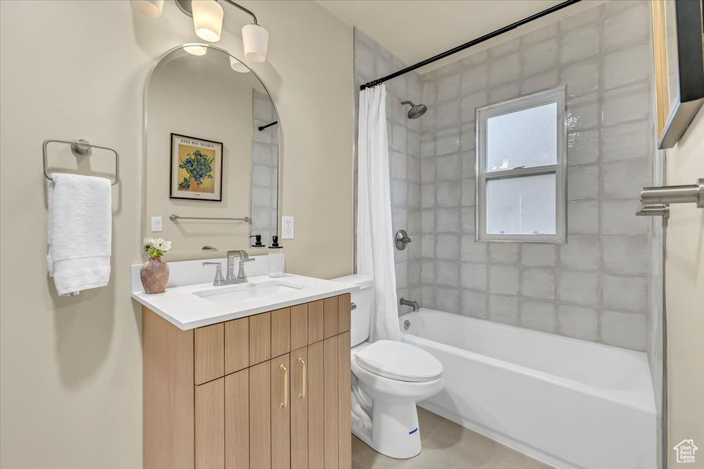 Full bathroom with vanity, shower / tub combo with curtain, and tile patterned flooring