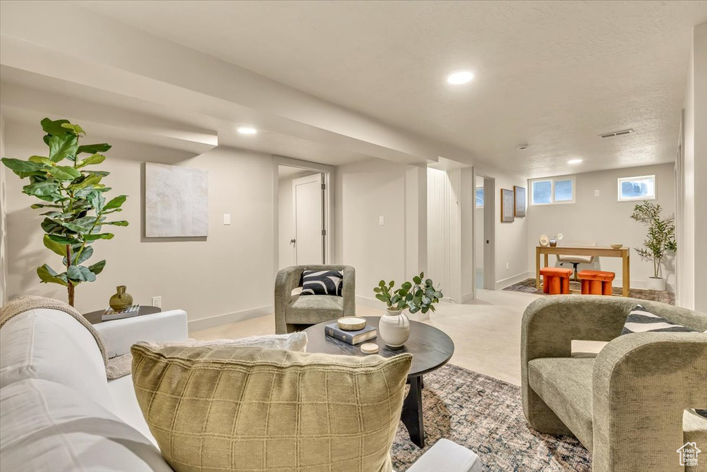 Living room with light carpet and recessed lighting
