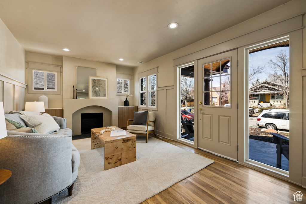 Living area featuring recessed lighting, light wood-style flooring, and a fireplace