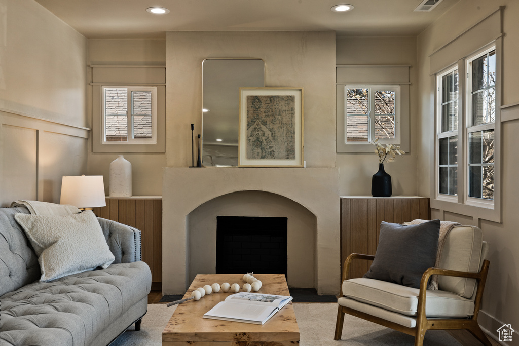 Living room with recessed lighting and a decorative wall