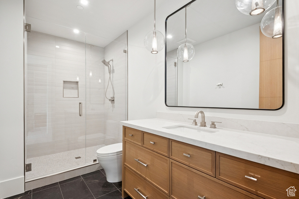 Bathroom featuring a shower stall, vanity, and recessed lighting