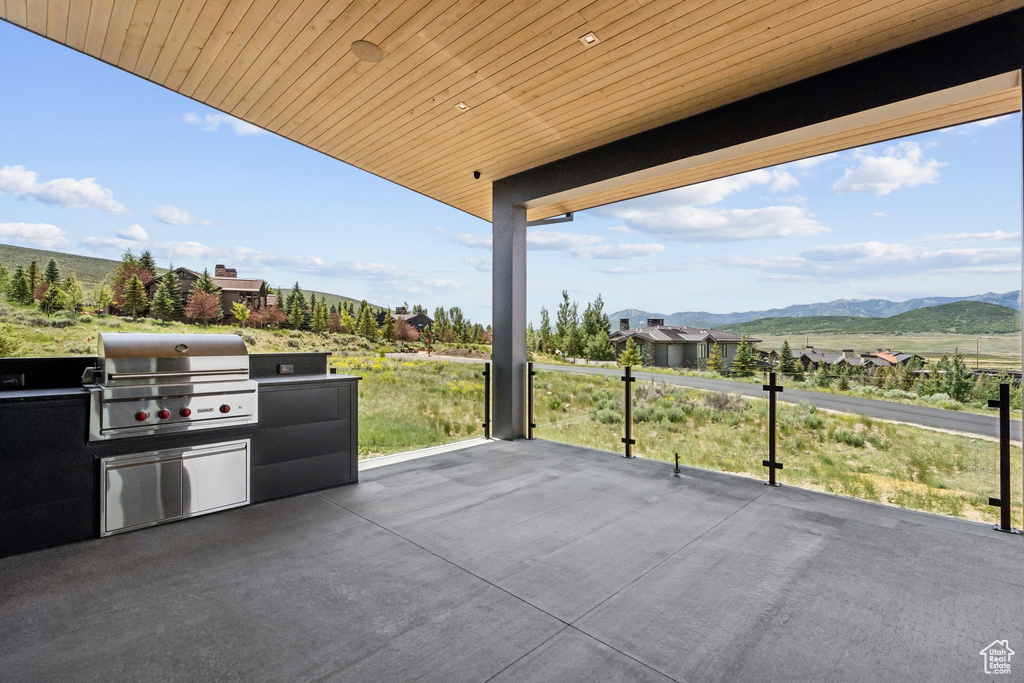 View of patio with an outdoor kitchen and a mountain view