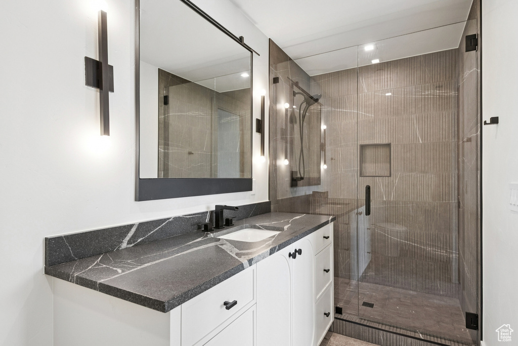 Full bath featuring vanity, a shower stall, and recessed lighting