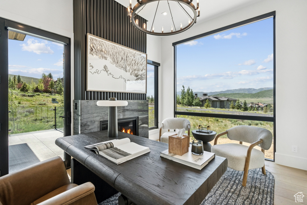 Sunroom with a chandelier and a mountain view