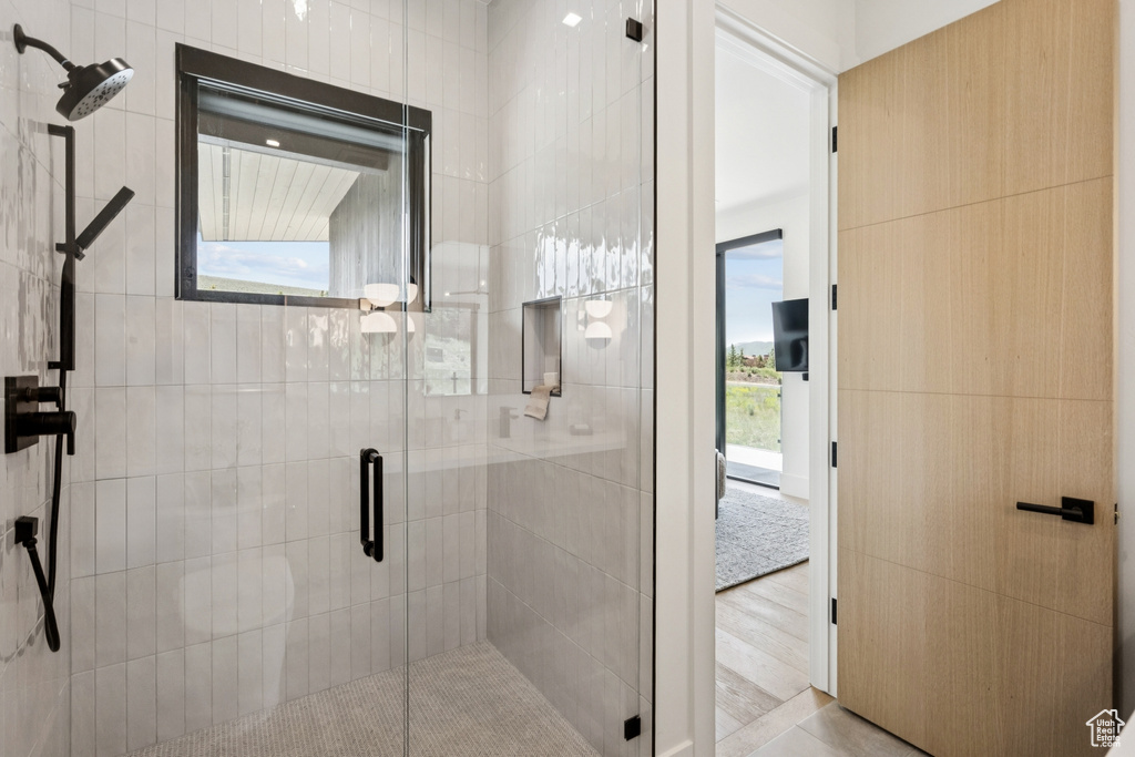 Bathroom featuring plenty of natural light and a stall shower