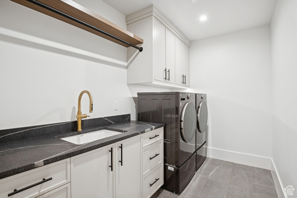 Laundry room featuring washing machine and clothes dryer, cabinet space, recessed lighting, and light tile patterned floors