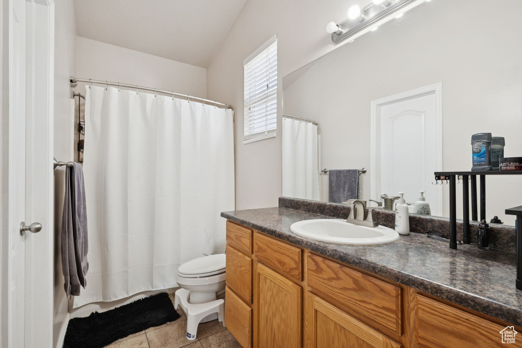 Full bath featuring vanity and tile patterned flooring