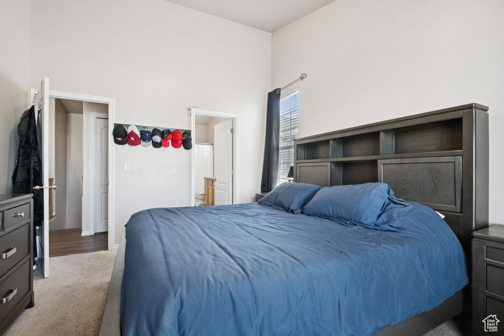 Bedroom featuring light carpet