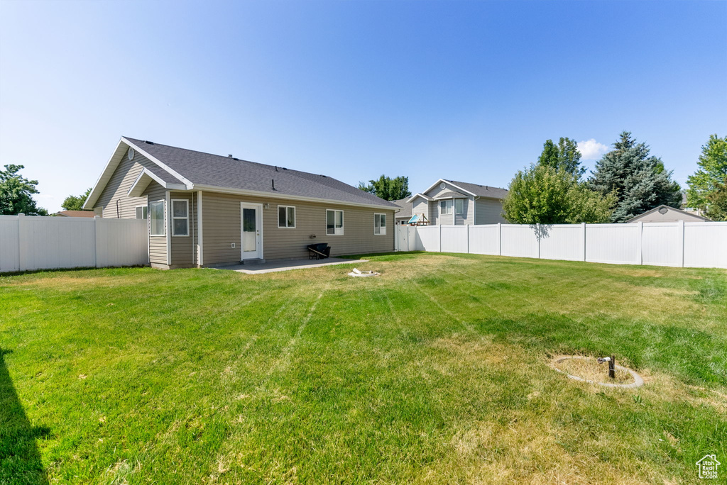 Back of house featuring a fenced backyard and a patio area