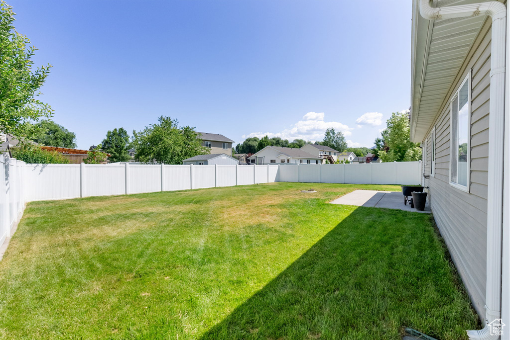 Fenced backyard with a patio