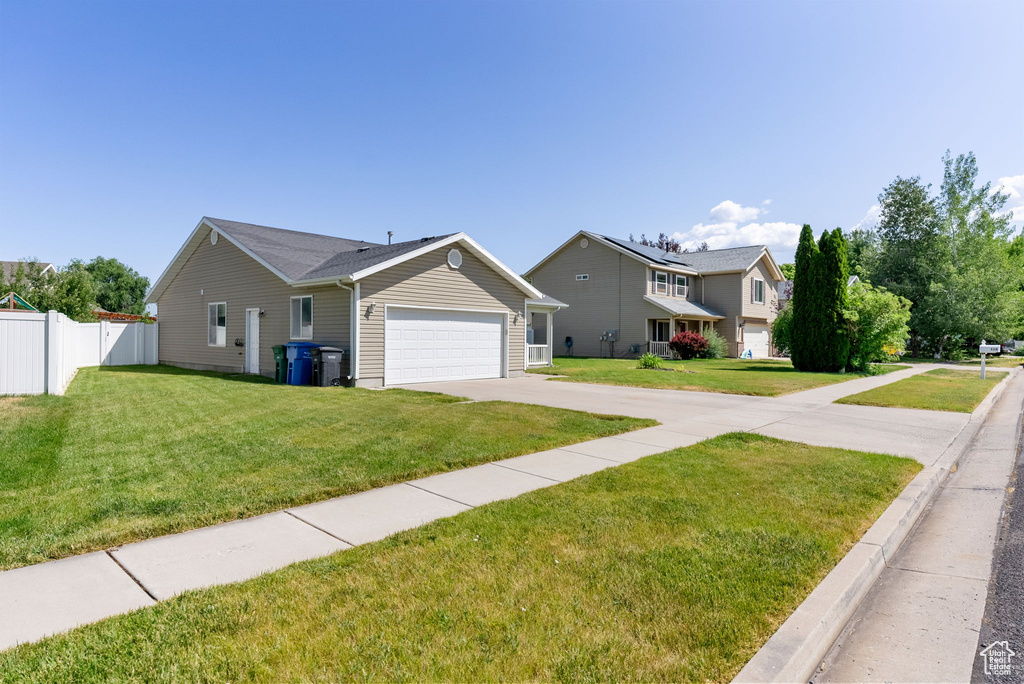 View of front of property featuring driveway and a garage