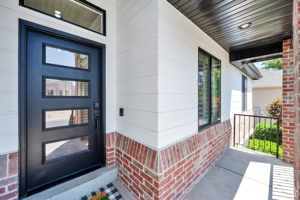 Entrance to property featuring covered porch