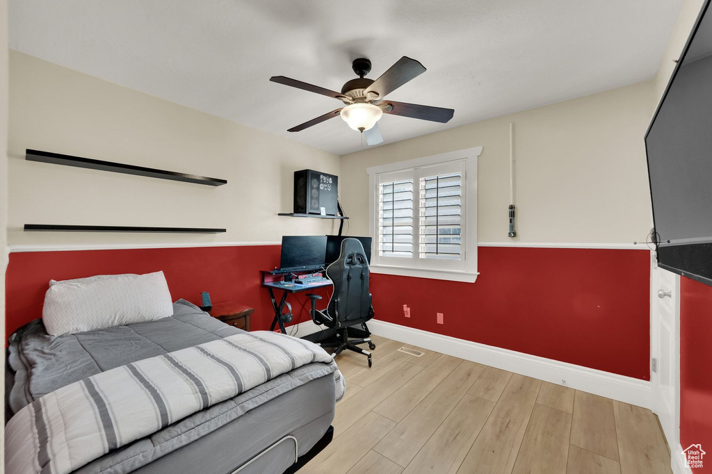 Bedroom with wood finished floors and a ceiling fan