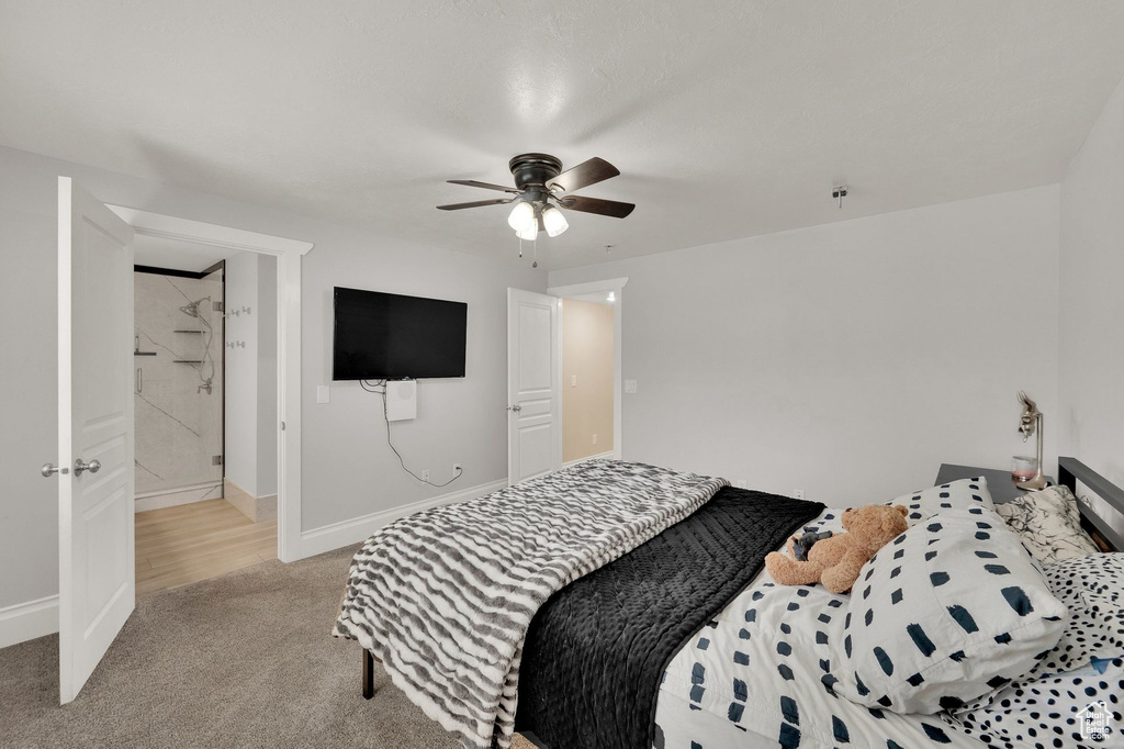 Bedroom featuring light carpet and a ceiling fan
