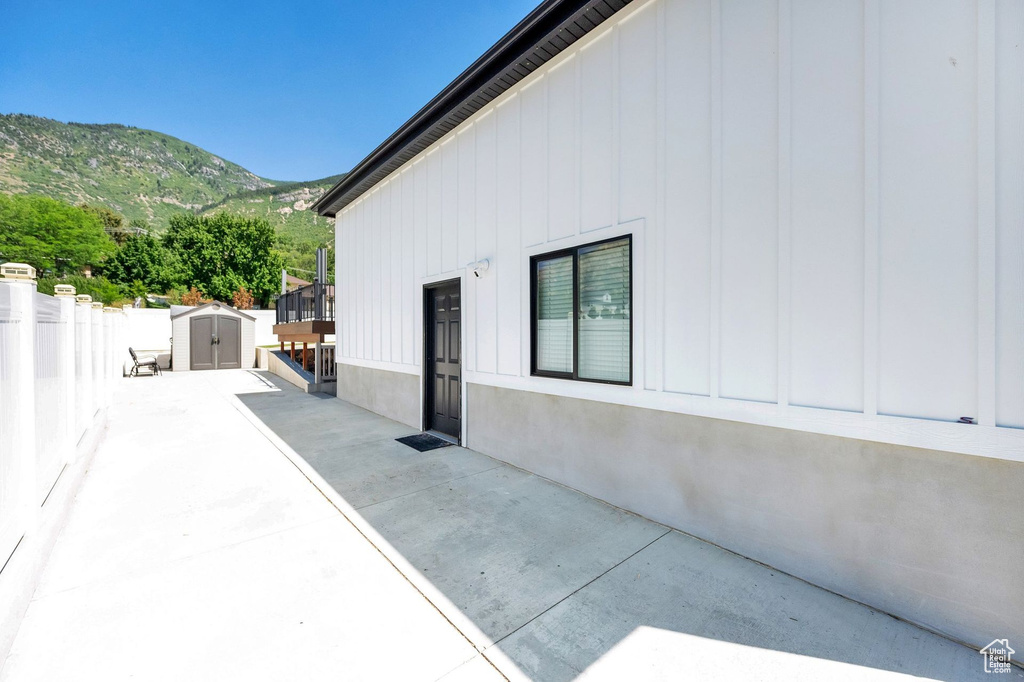 View of patio featuring a shed and a mountain view