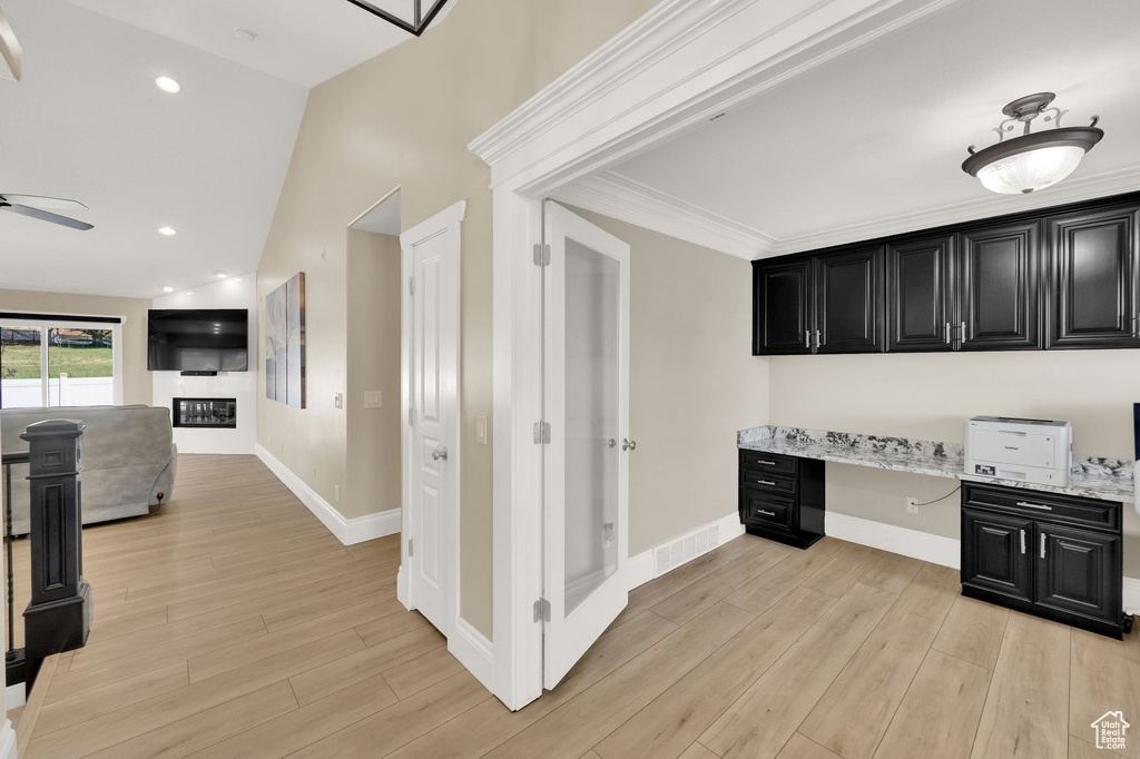 Corridor with a desk and light wood finished floors