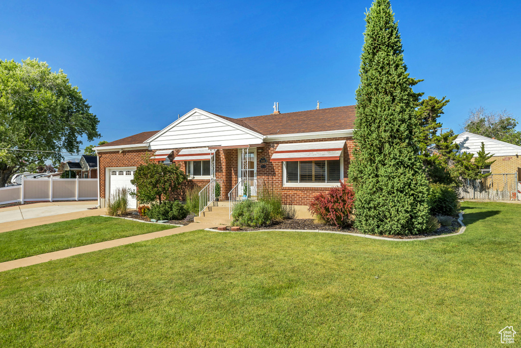 View of front of home featuring brick siding, an attached garage, concrete driveway, and roof with shingles