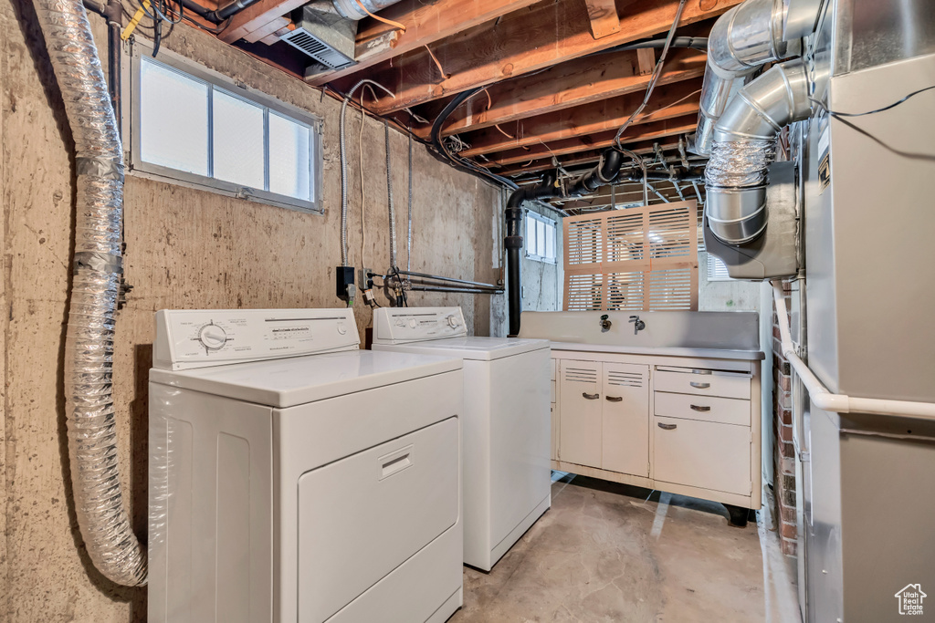 Laundry room featuring washing machine and dryer and cabinet space