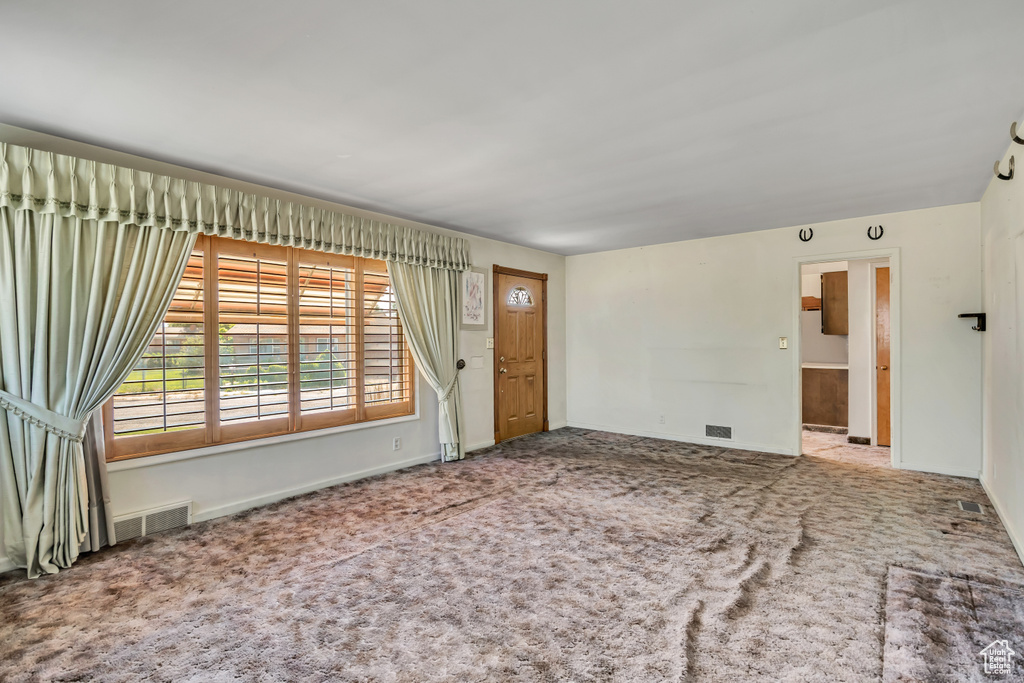 Unfurnished living room with carpet floors