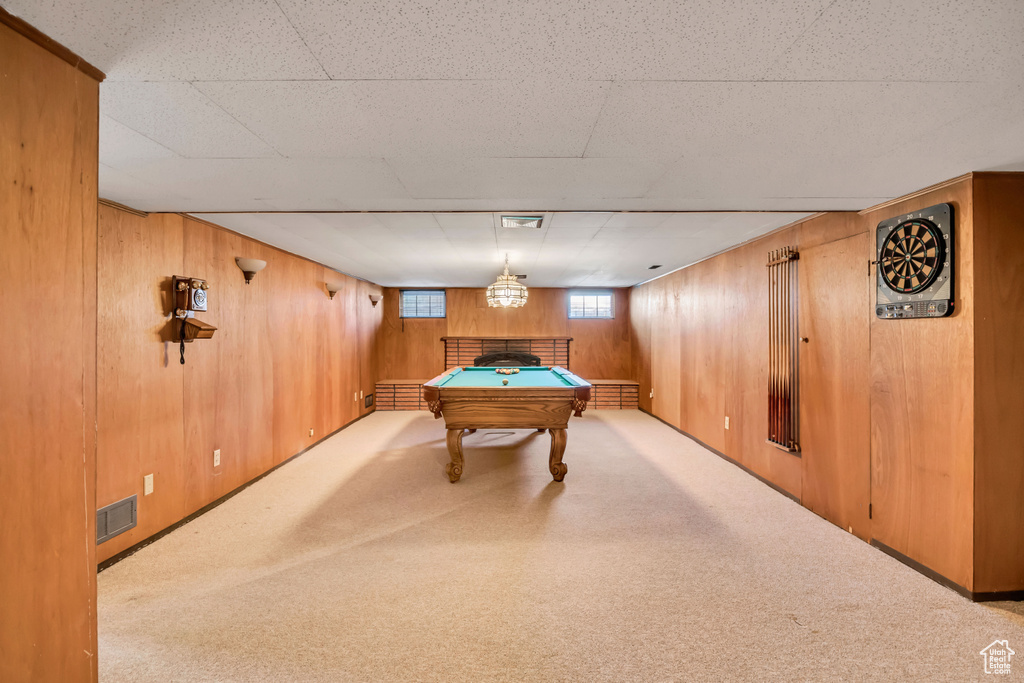 Game room featuring pool table, wooden walls, and carpet