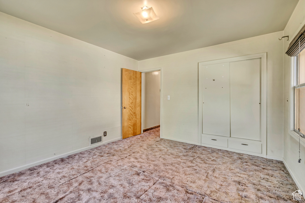 Unfurnished bedroom with carpet floors and a closet