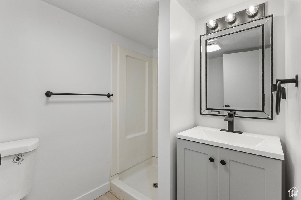 Bathroom with vanity and a shower stall