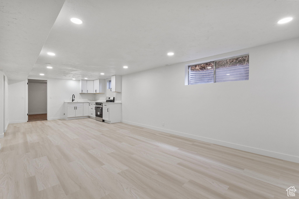 Unfurnished living room featuring recessed lighting and light wood-style flooring
