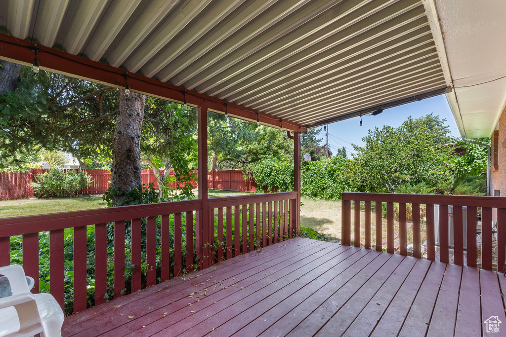 Wooden deck with a fenced backyard