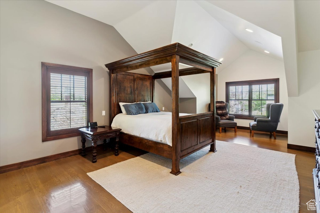 Bedroom featuring vaulted ceiling, wood finished floors, and recessed lighting