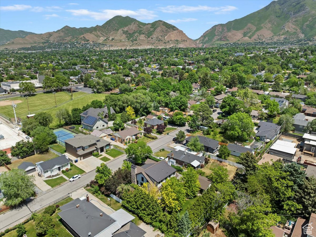 Aerial overview of property's location featuring a mountainous background and nearby suburban area