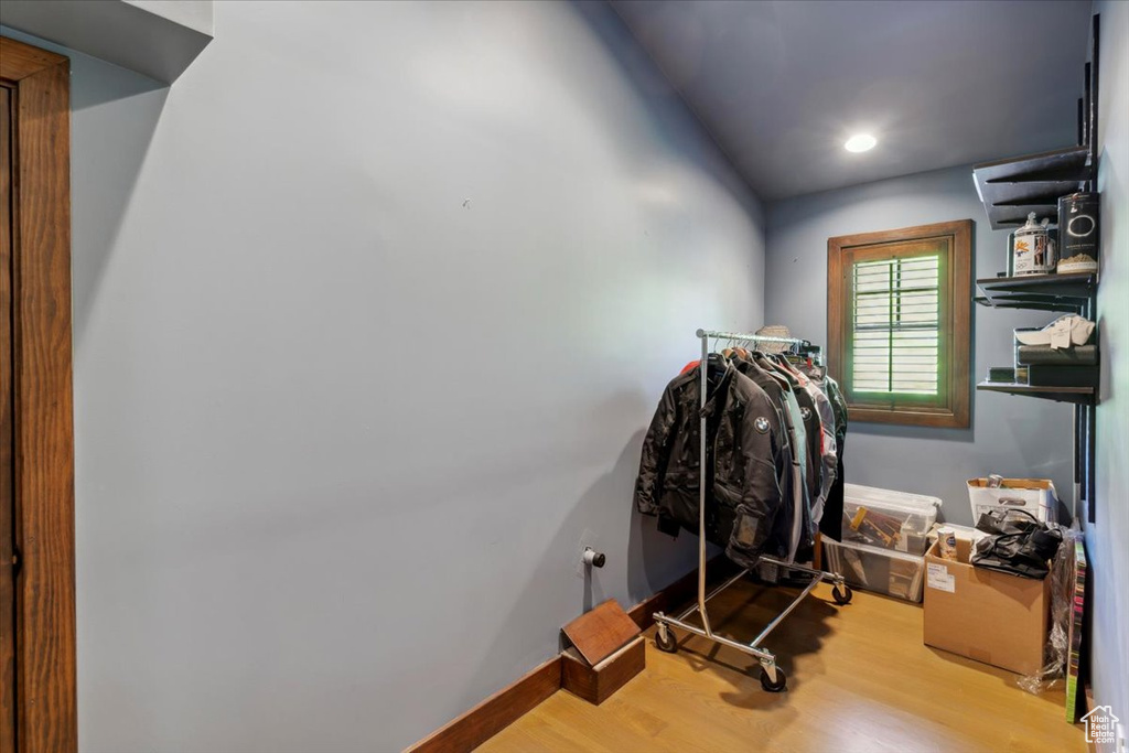 Workout area with wood finished floors and recessed lighting