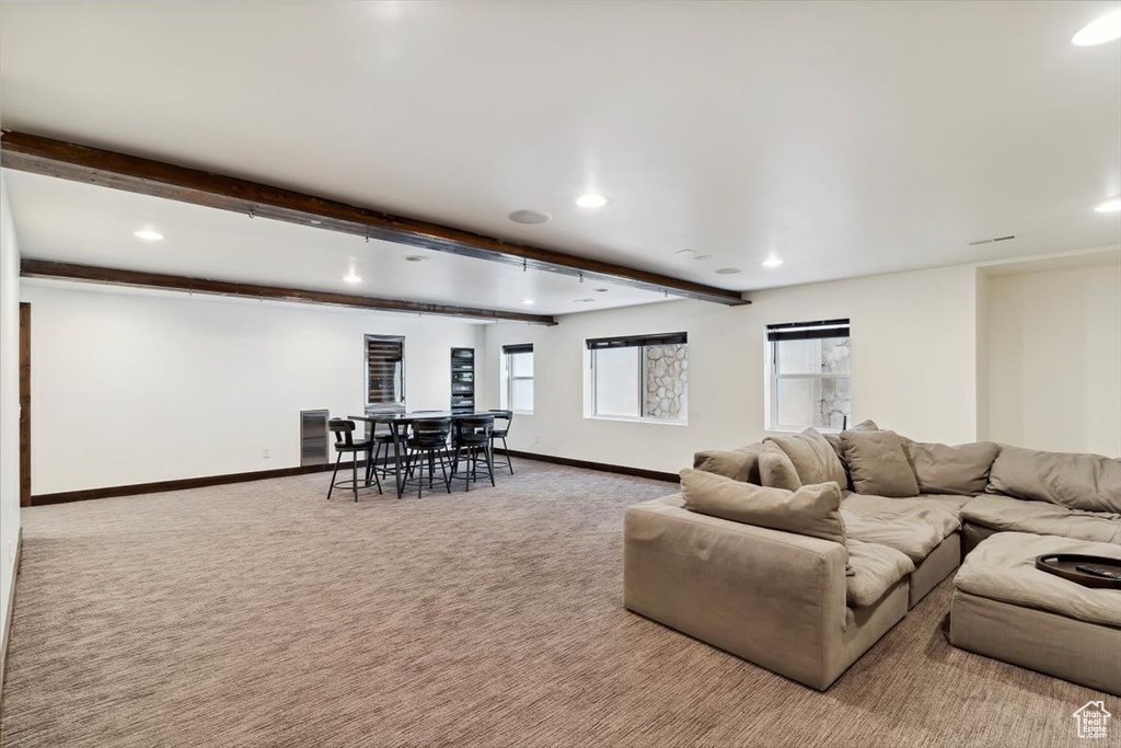 Living room with carpet, recessed lighting, and beamed ceiling