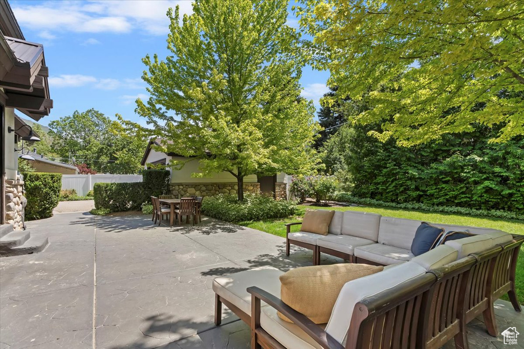 Fenced backyard featuring an outdoor living space, outdoor dining area, and a patio area