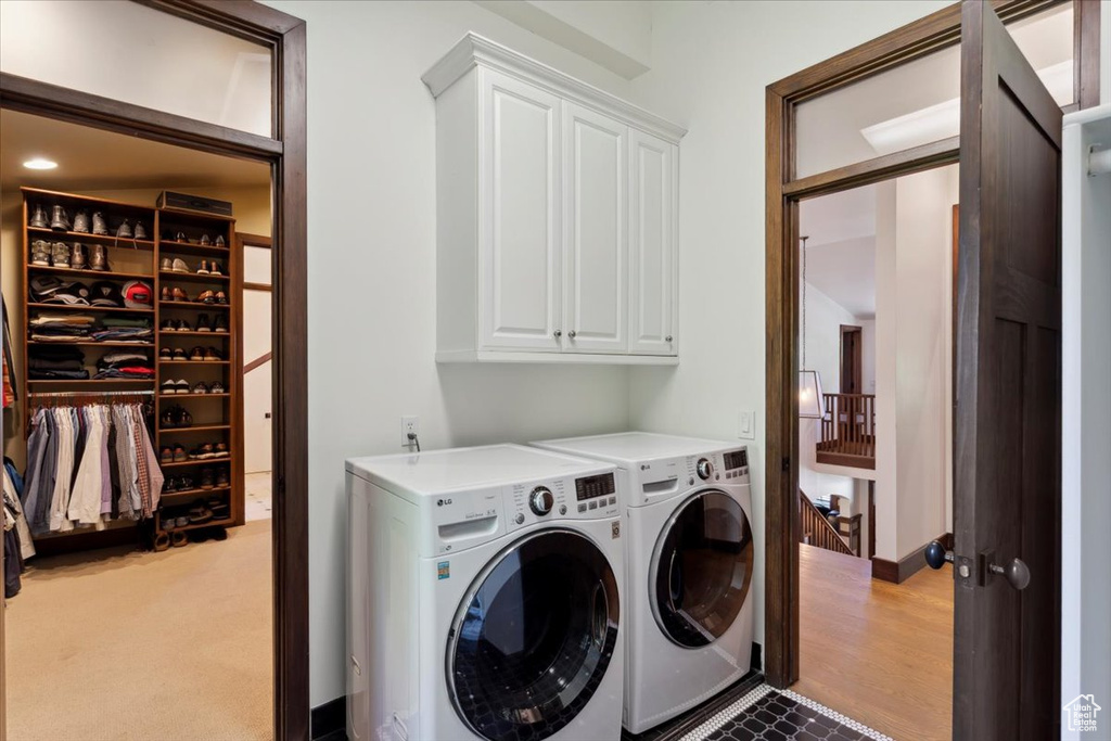 Laundry room featuring cabinet space and washer and dryer