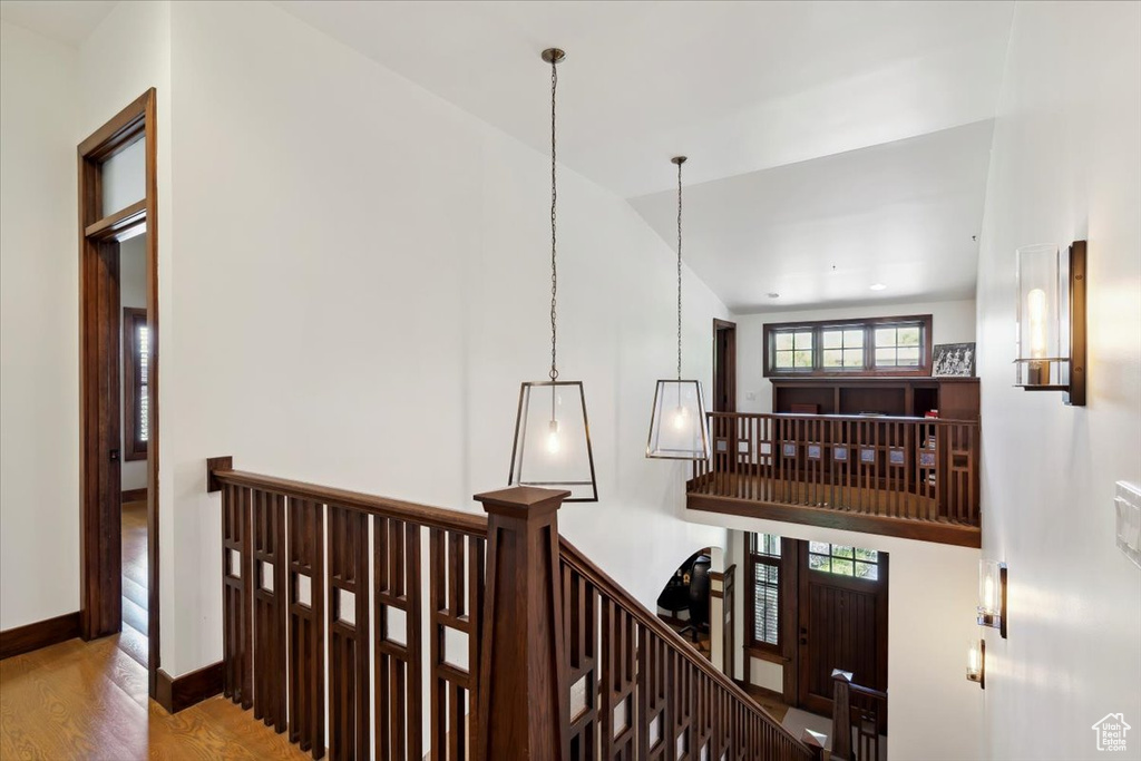Hall with an upstairs landing and wood finished floors