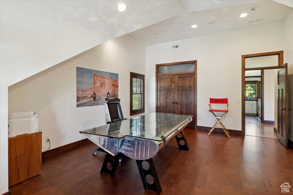 Dining space with recessed lighting, wood finished floors, and a towering ceiling