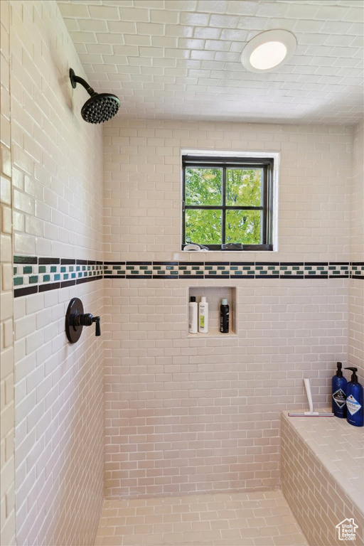 Full bath featuring tiled shower
