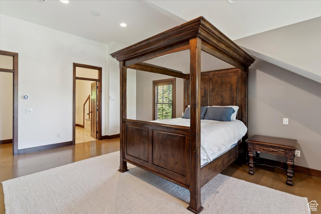 Bedroom with wood finished floors and recessed lighting