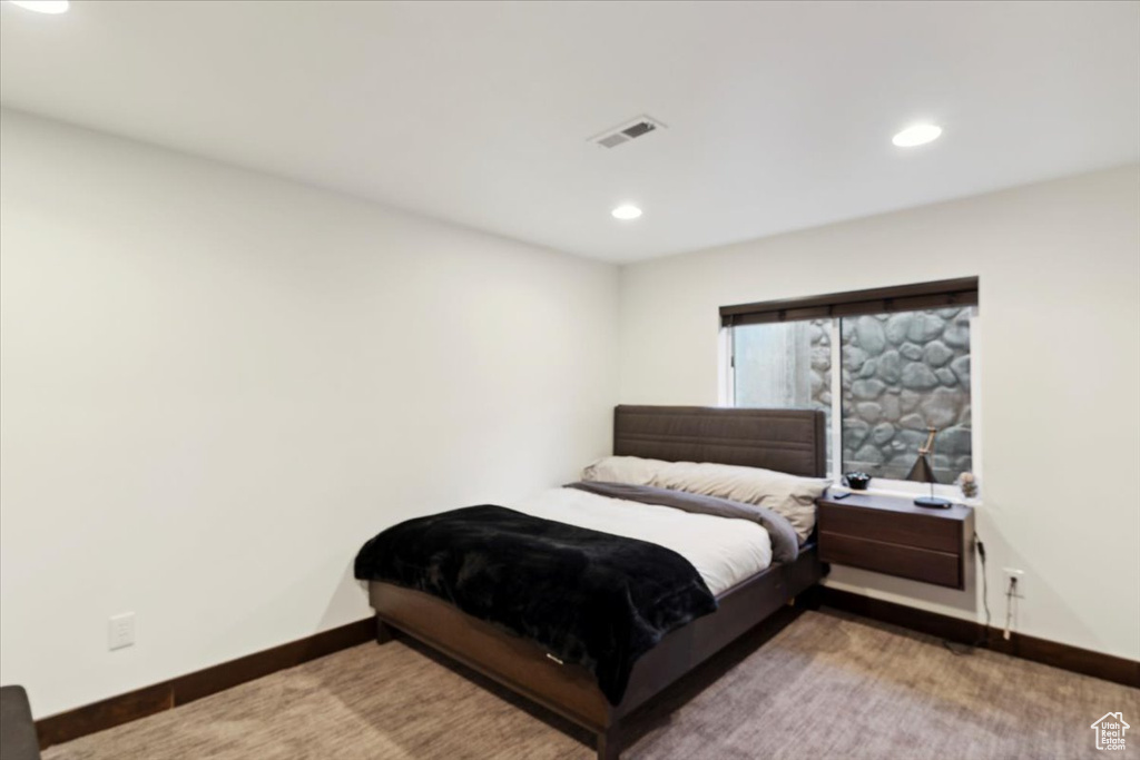 Carpeted bedroom with recessed lighting