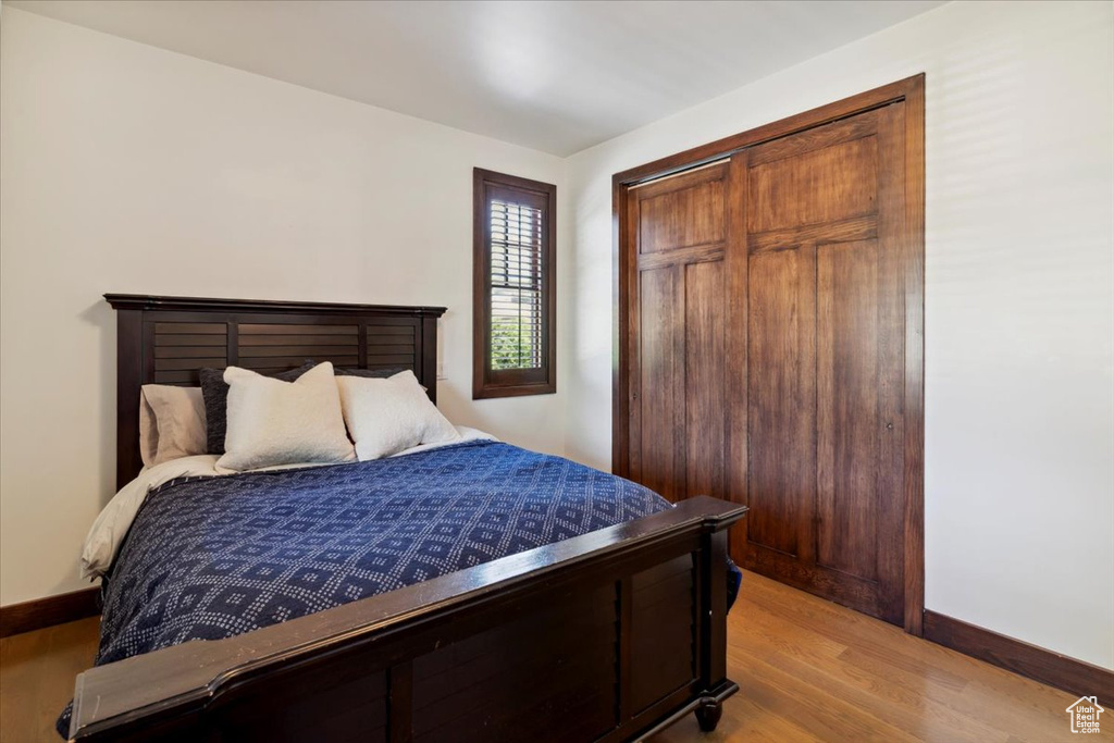 Bedroom with light wood-type flooring and a closet