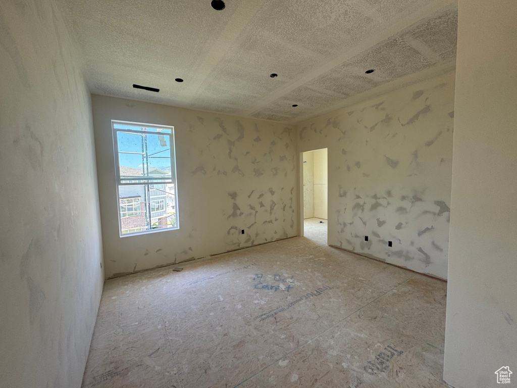 Empty room featuring a textured ceiling