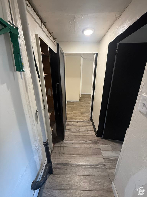 Corridor featuring light wood-type flooring