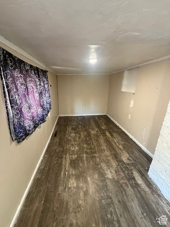 Finished basement featuring wood finished floors and baseboards