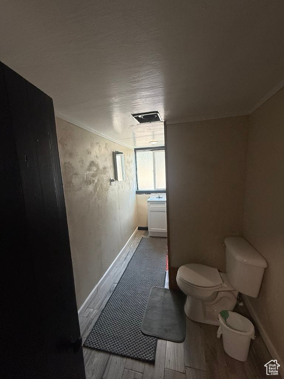 Bathroom with wood finished floors and toilet