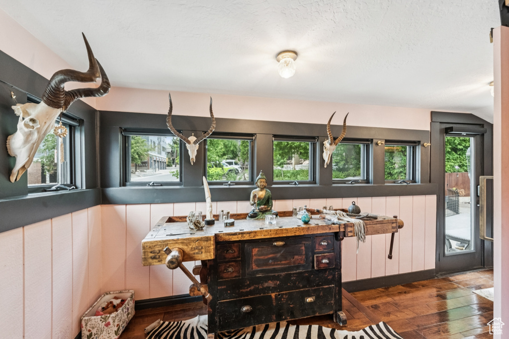 Dining area with wood-type flooring and lofted ceiling