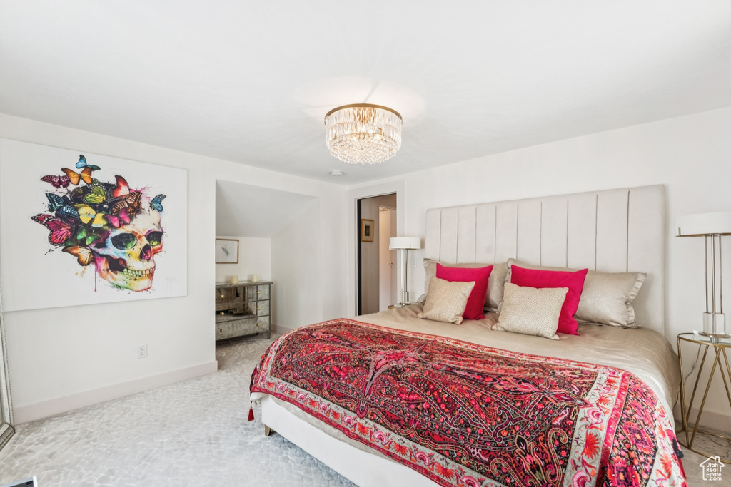 Bedroom with carpet floors and a chandelier