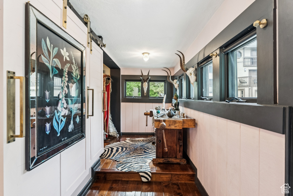 Corridor featuring hardwood / wood-style floors and a barn door