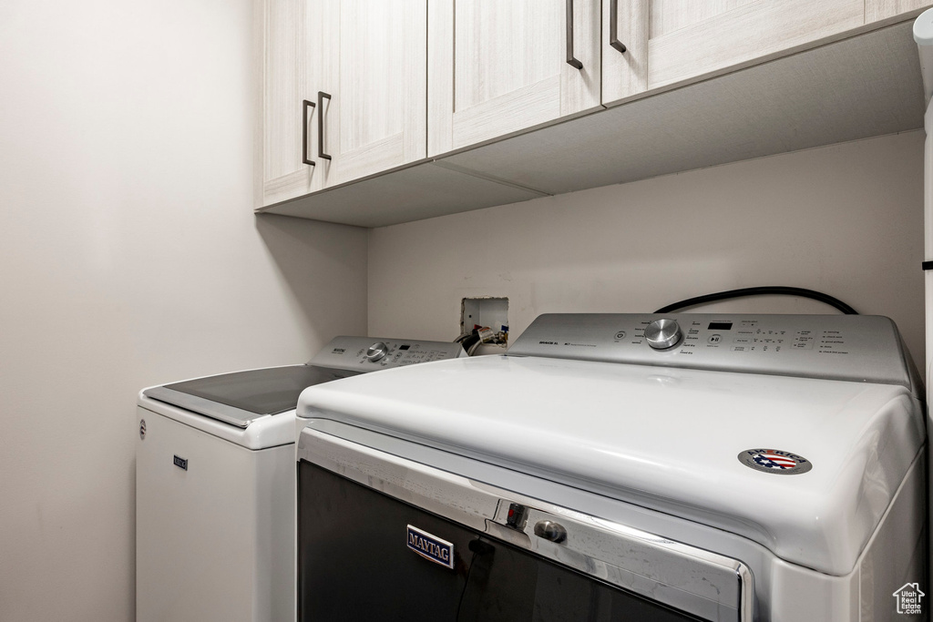 Laundry area with cabinet space and washing machine and dryer