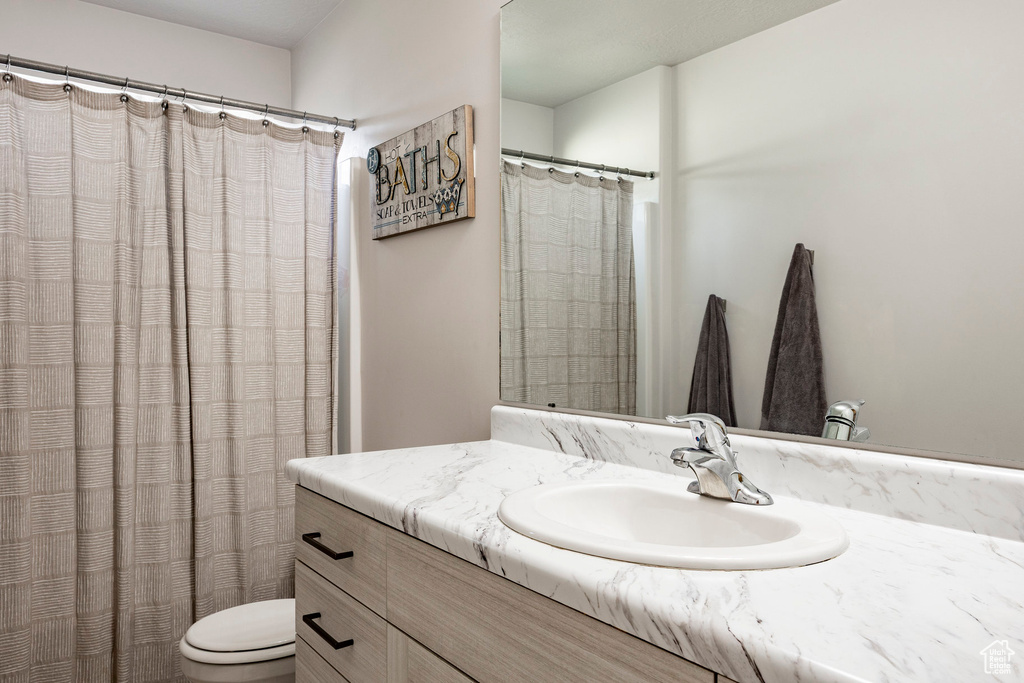Full bathroom with vanity and a shower with shower curtain